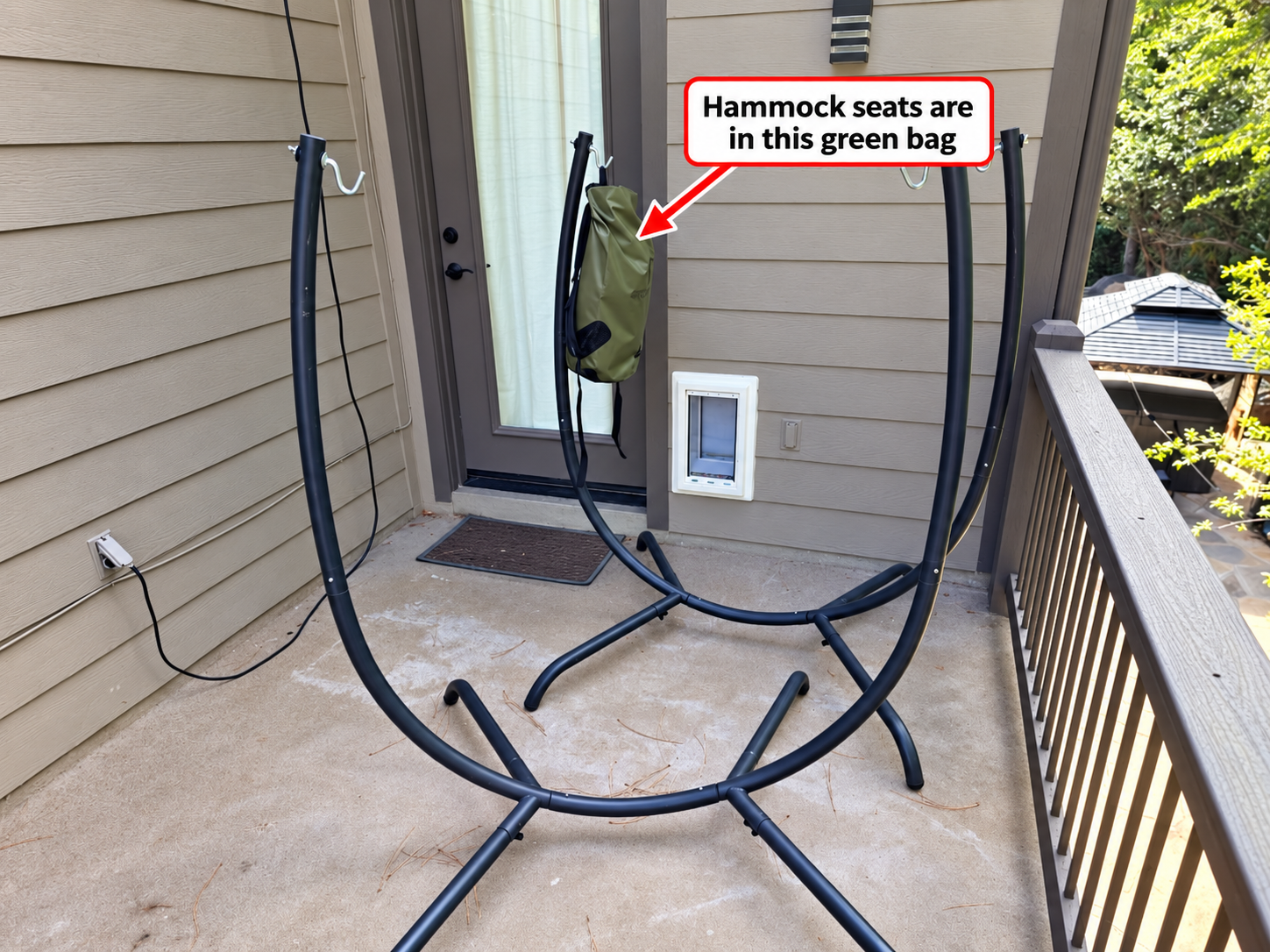 Back-deck hammock stands; an arrow points to the green bag hanging beside the door where the seats are stored.