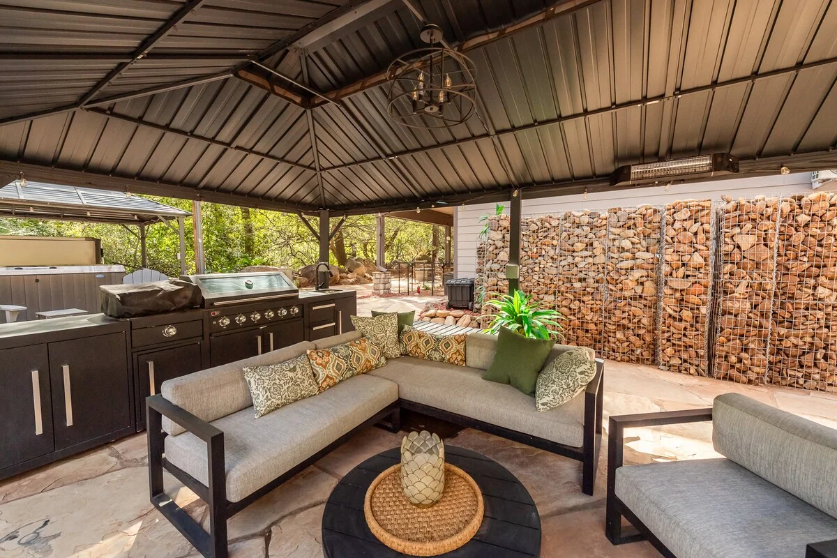 Covered outdoor lounge with comfortable seating and canyon surroundings